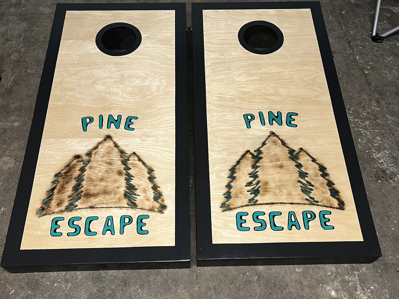 Custom cornhole boards reading Pine Escape with pine tree graphics