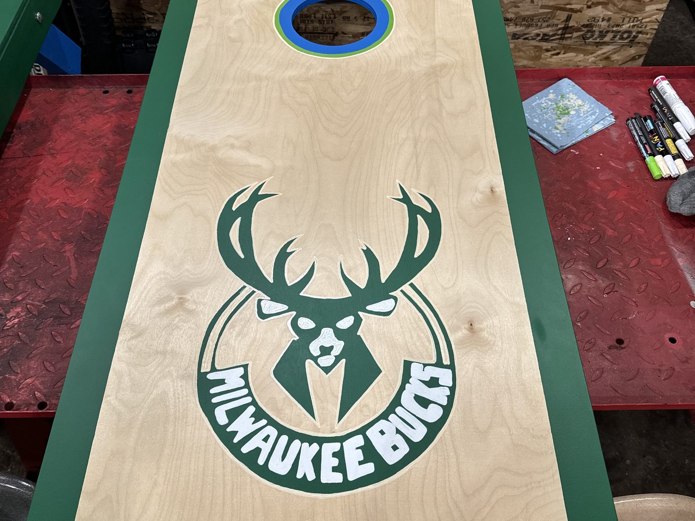 Custom cornhole board with Milwaukee Bucks deer logo