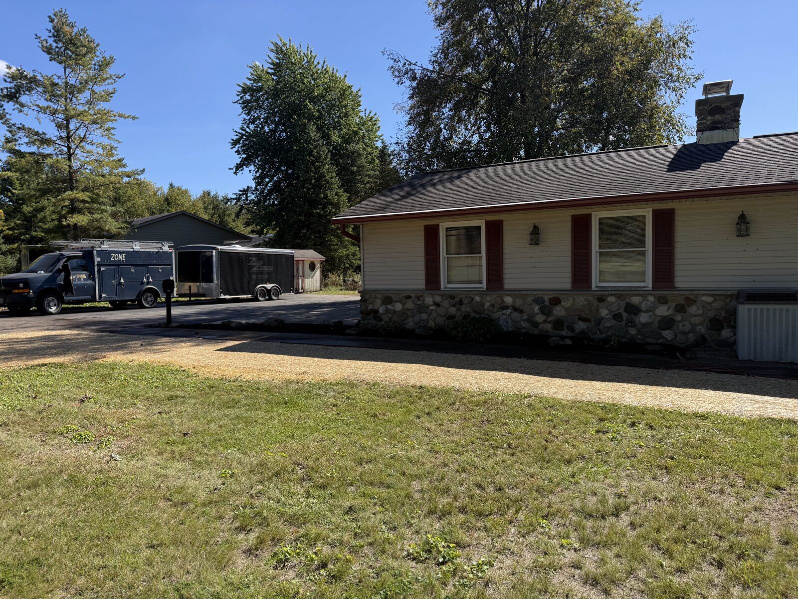 Cleaned-up front yard with new topsoil and a fresh lawn, after