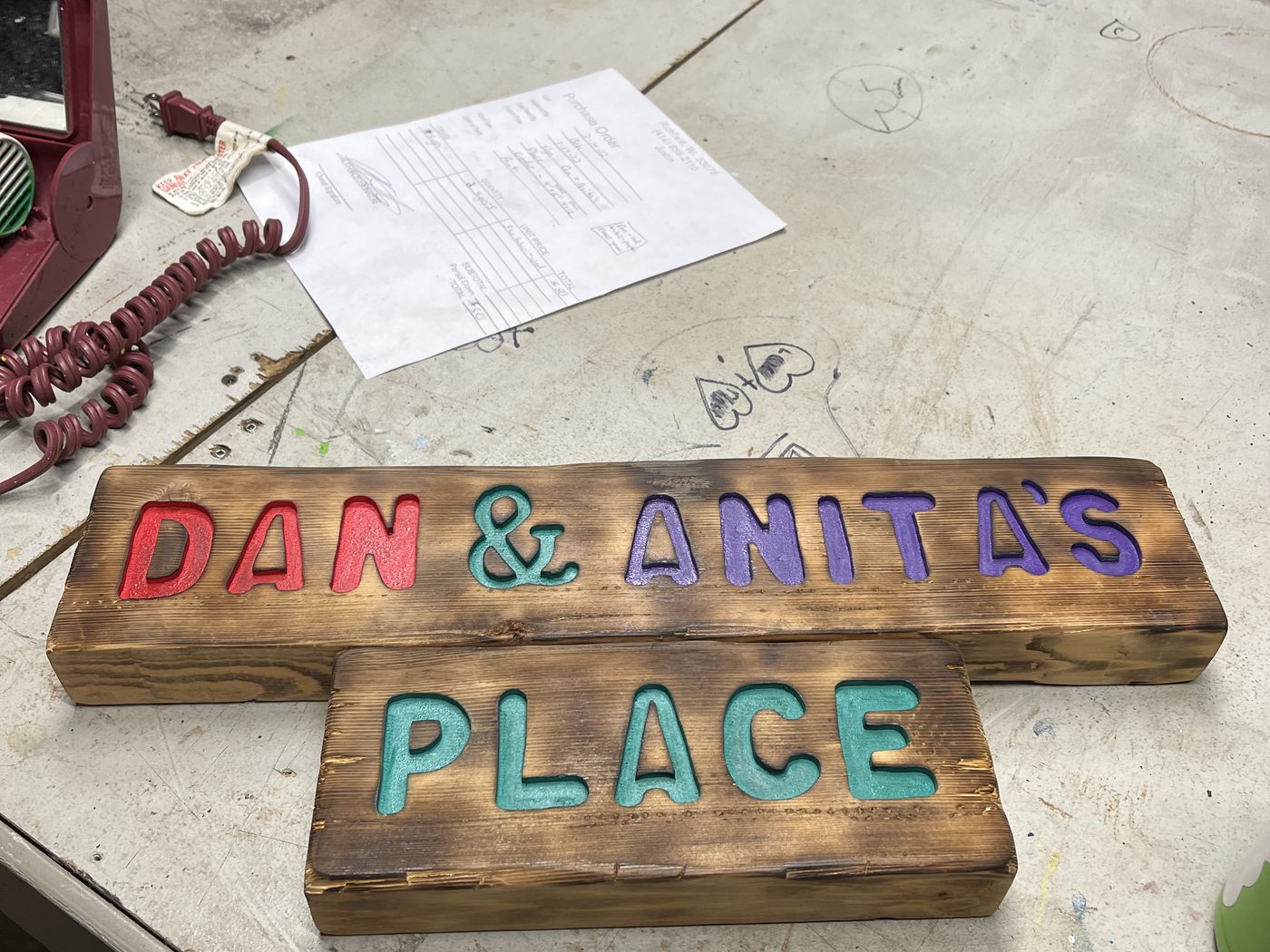 Custom painted wood sign reading Dan and Anita's Place