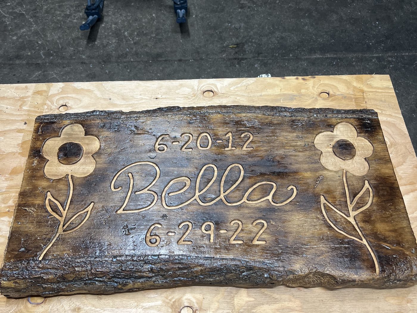 Custom engraved pet memorial sign with painted flowers