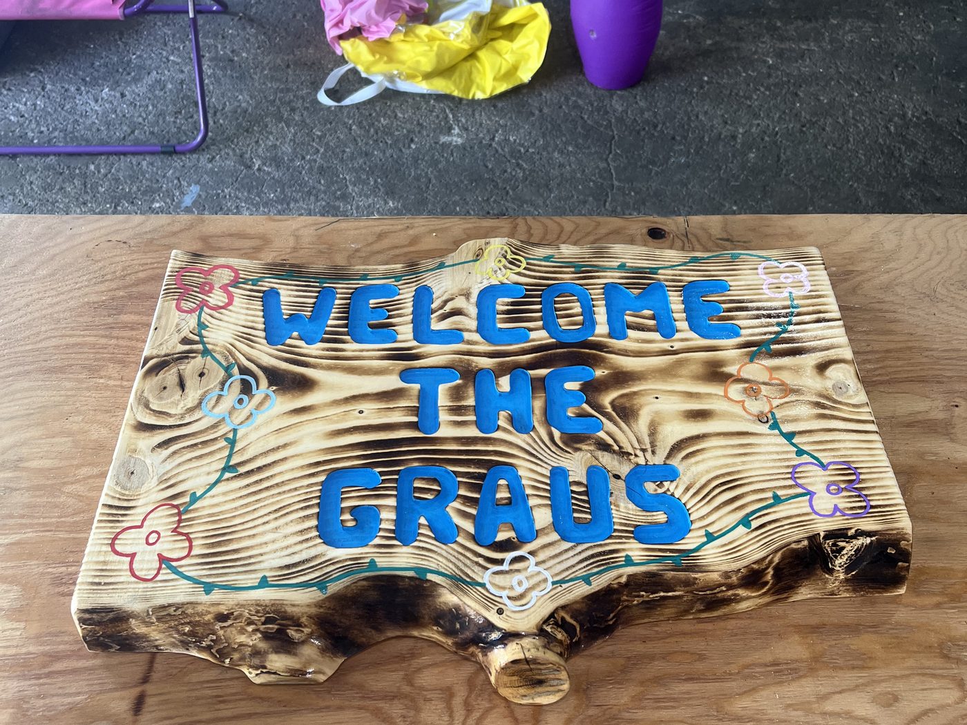 Custom welcome sign carved into a rustic wood slice